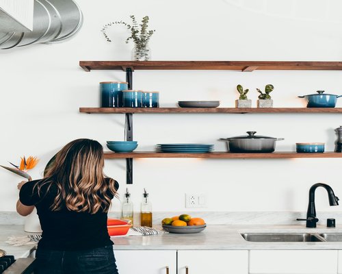 Person preparing a healthy vibrant salad in a bright kitchen